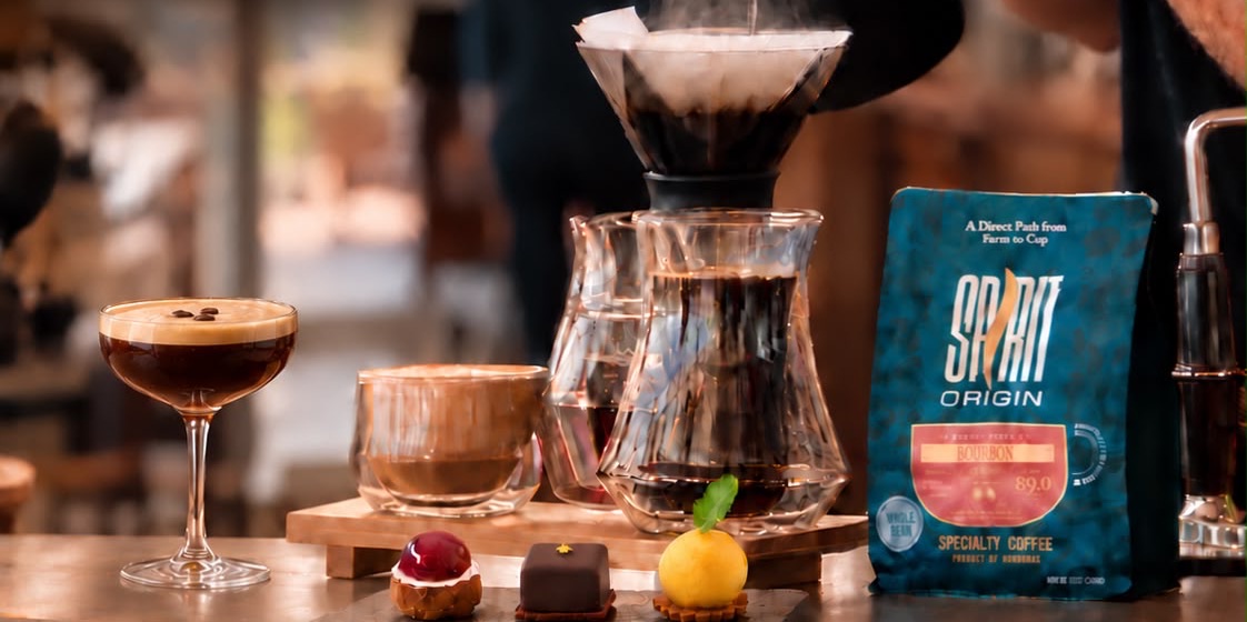 An espresso martini, a latte, filter coffee, three small bites and a bag of Spirit Origin Bourbon coffee on the bar
