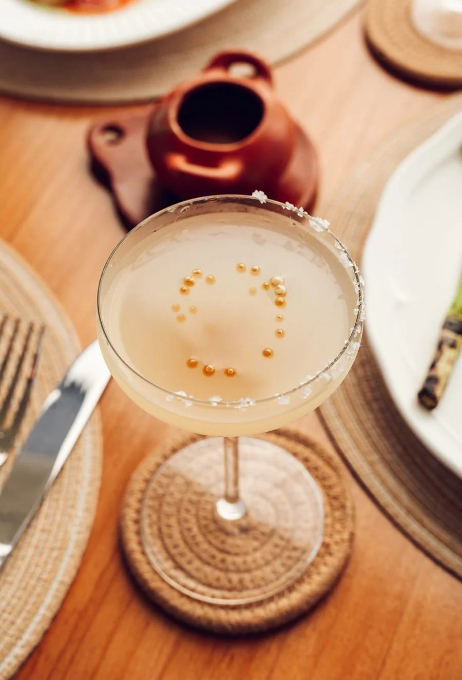 A pale cocktail in a coupe