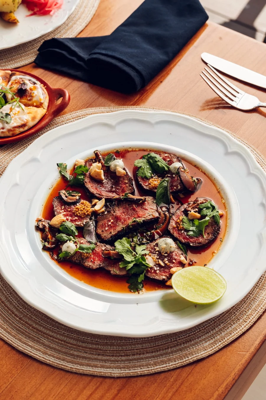 Seared meat with sauce and greens