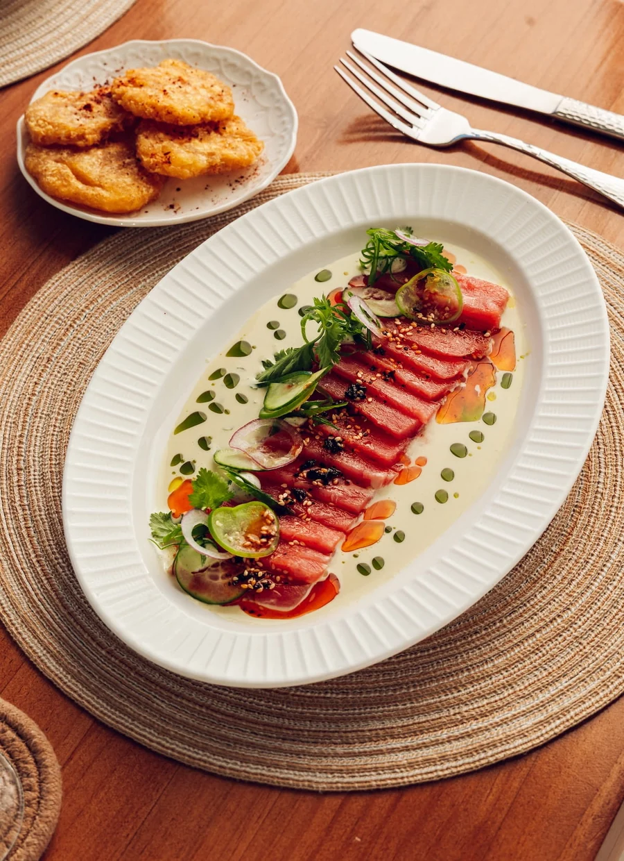 Sliced seared fish with herbs