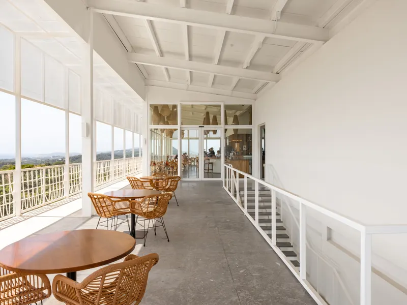 The East Terrace: a covered gallery with round tables and wide views across the island