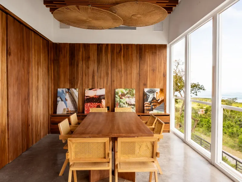 The Private Room: a long wooden table, wood-panelled walls, coffee photographs and a window onto the island